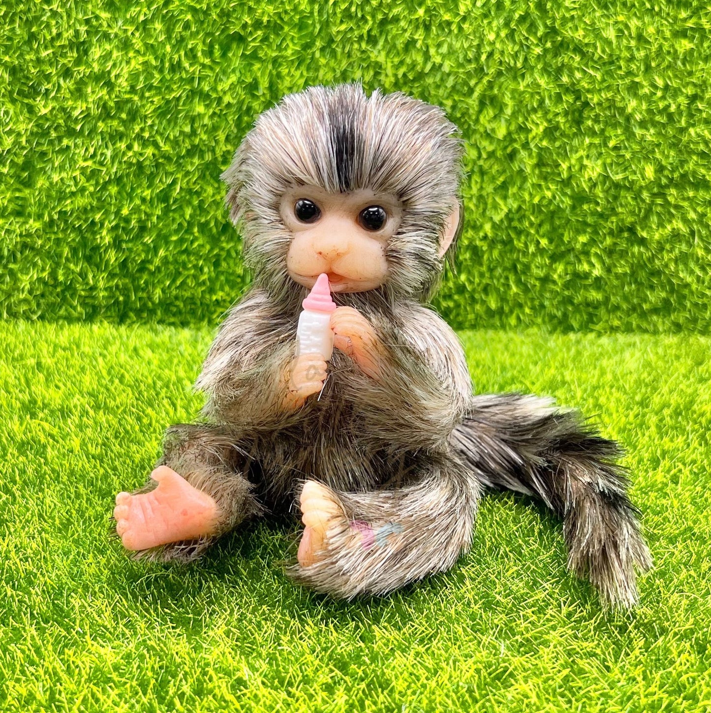 Finger Marmoset Monkey Holding Milk Bottle