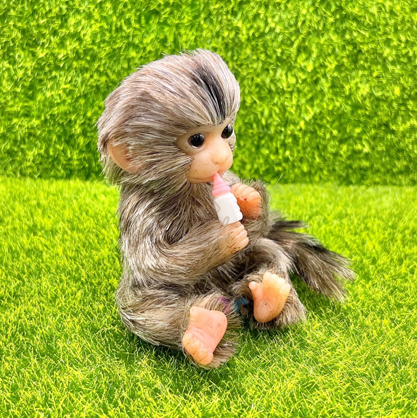 Finger Marmoset Monkey Holding Milk Bottle